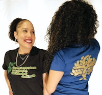 two women wearing t - shirts with a tree on them